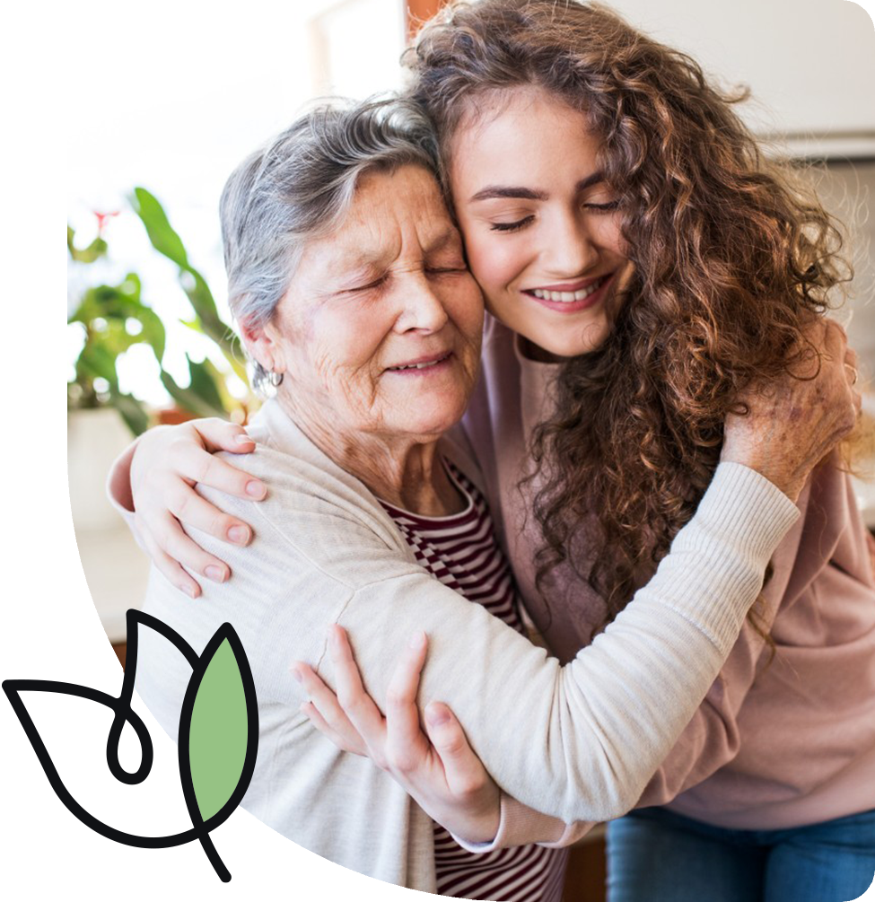 Caregiver giving hug to senior
