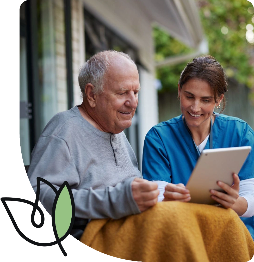 caregiver and senior reading from an ipad caregiver and senior reading from an ipad